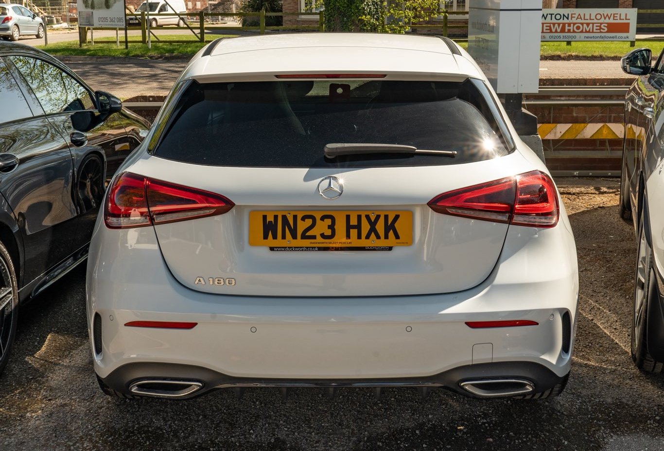 Rear view of a white Mercedes-Benz A180 with registration plate WN23 HXK.