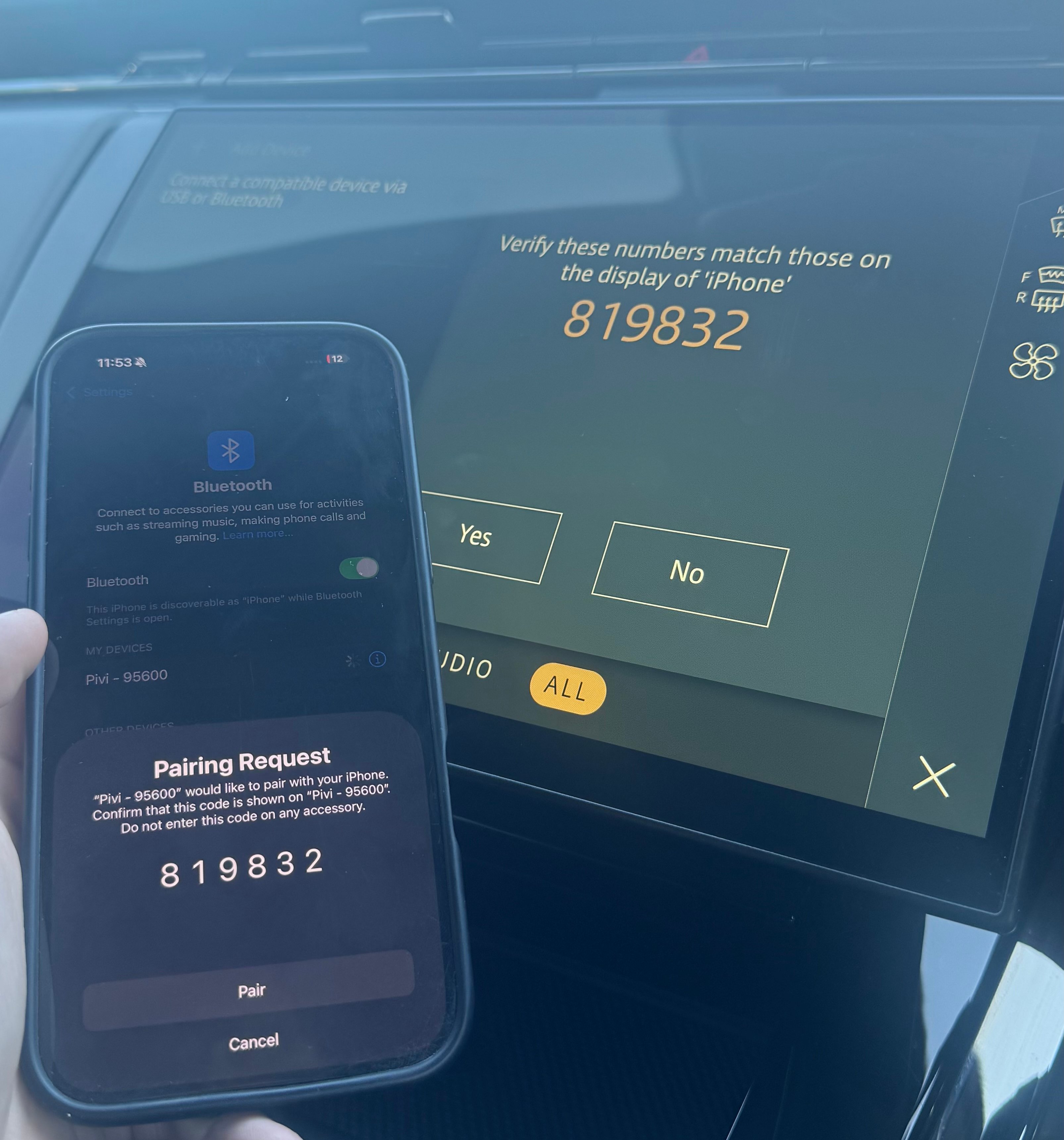 Car display and phone screen showing Bluetooth pairing code 819832.