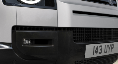 Close-up of front grille and headlight of a Land Rover vehicle with plate I43 UYP.