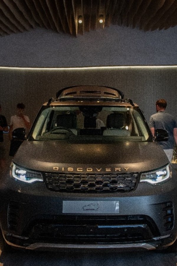 Front view of a Land Rover Discovery in a showroom setting.