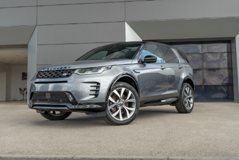 Silver SUV parked outside a building.