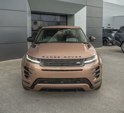 Front view of a bronze Range Rover parked on a concrete surface.