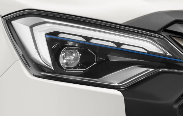 Silver Isuzu D-Max pickup truck parked on grass.