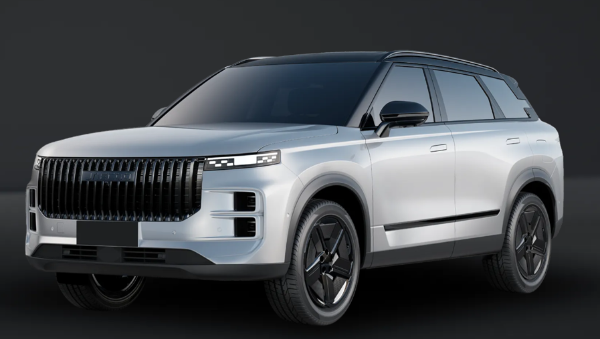 Silver SUV with dark-tinted windows and a prominent front grille, viewed from the front side.