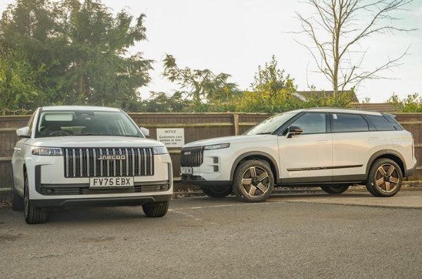 Two white SUVs parked side by side, front view and side view visible.