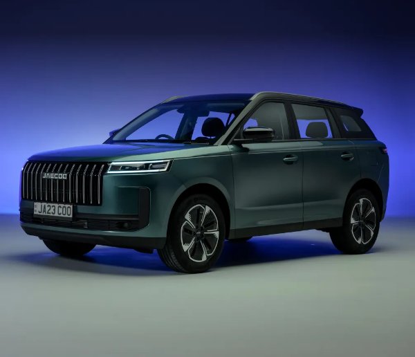 Dark green SUV with a distinctive front grille, viewed from the side.
