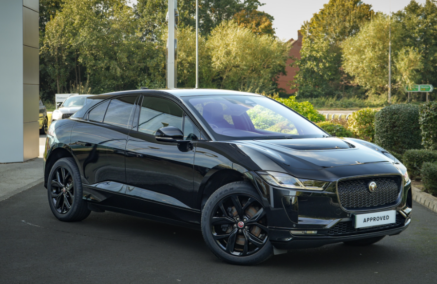 Black Jaguar SUV parked, showing side and front angle.