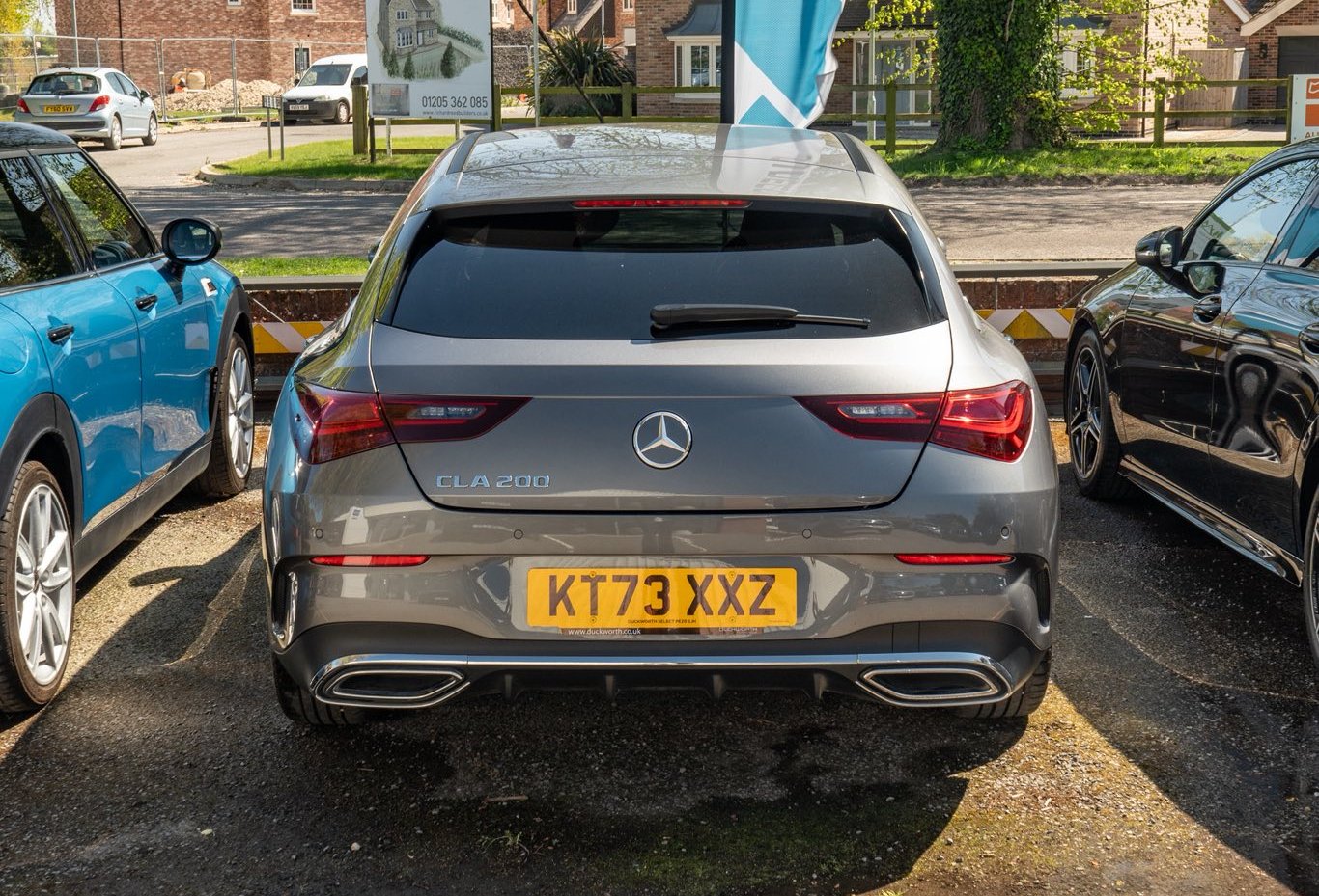 Rear view of a parked grey Mercedes-Benz CLA 200 with registration KT73 XXZ.