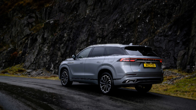 Silver SUV parked on a mountain road with a visible UK number plate.