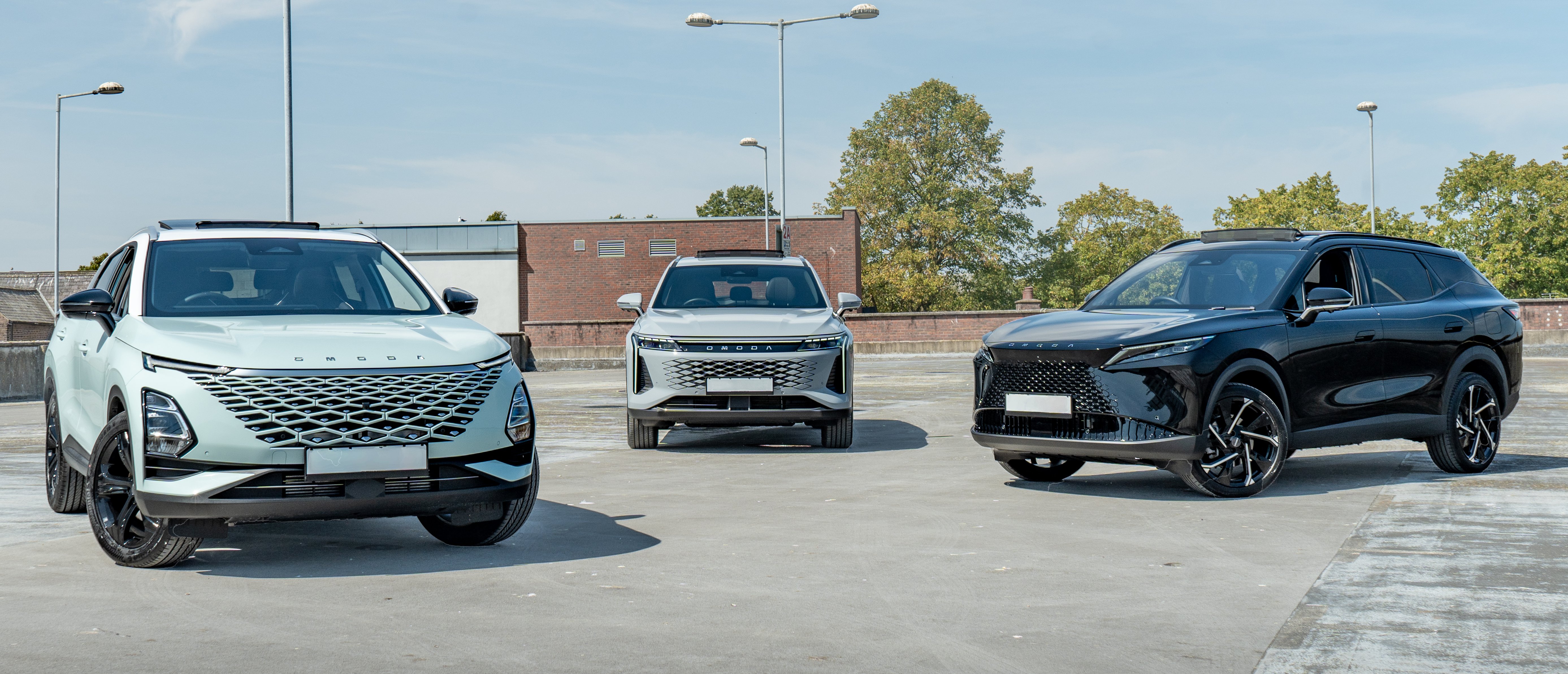 Three SUVs parked in a row in an outdoor setting.