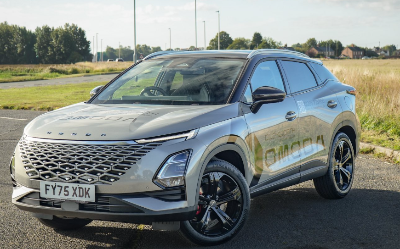 Silver SUV parked on rural road, angled front view.