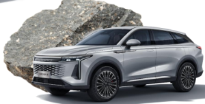 Silver SUV parked in front of a large rock.