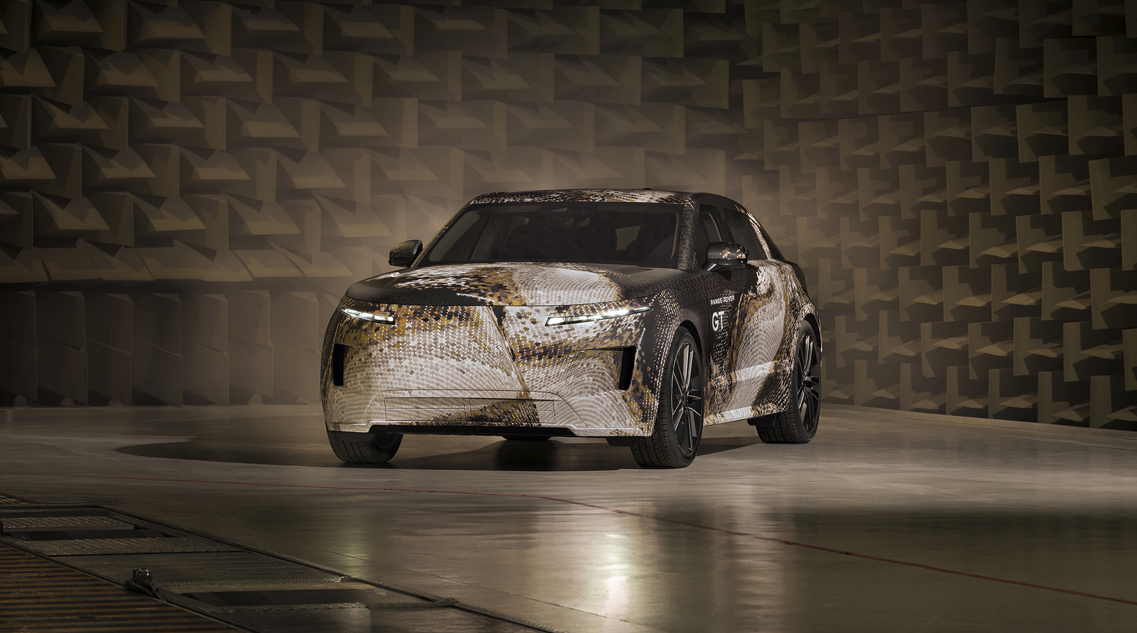 Camouflaged car in an automotive testing facility.
