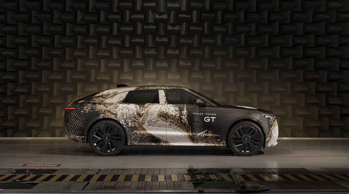 Side view of a Range Rover GT with camouflage wrap.