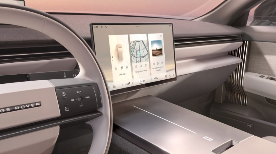 Range Rover interior with steering wheel and touchscreen display.