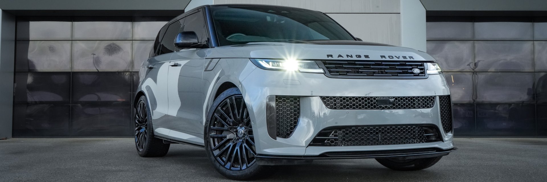 White Range Rover SUV parked outdoors.