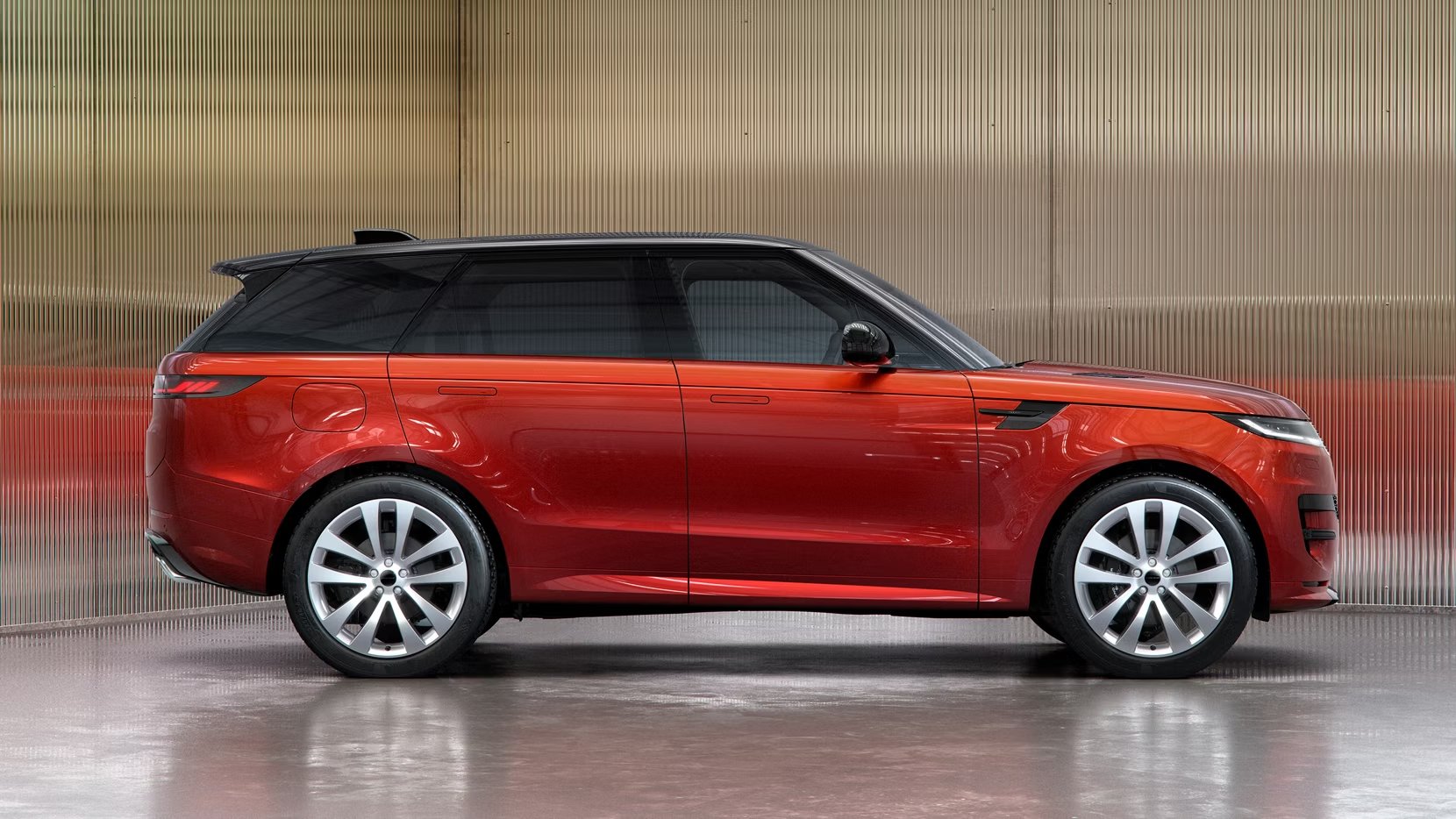 Red SUV ascending steep outdoor stone staircase with rocky cliffside in view.