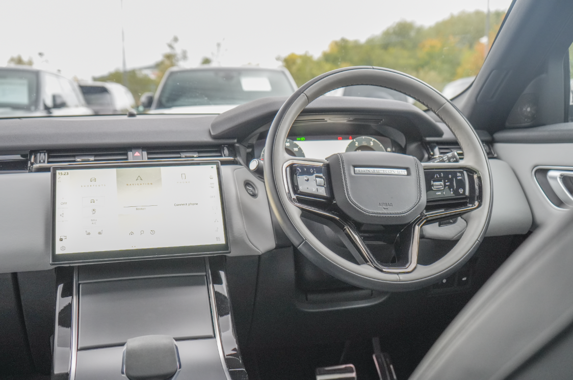 Range Rover dashboard with touchscreen display and steering wheel.