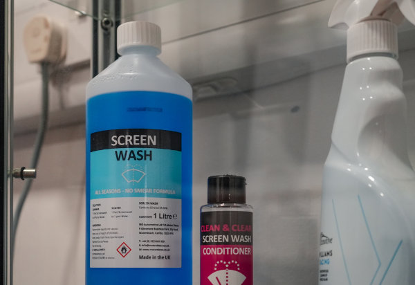 Blue screen wash and screen wash conditioner bottles on a shelf.