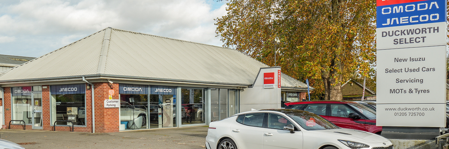 Car dealership with Isuzu and Duckworth Select signage.
