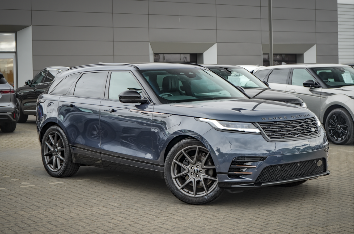 Dark grey Range Rover Velar parked on a pavement.